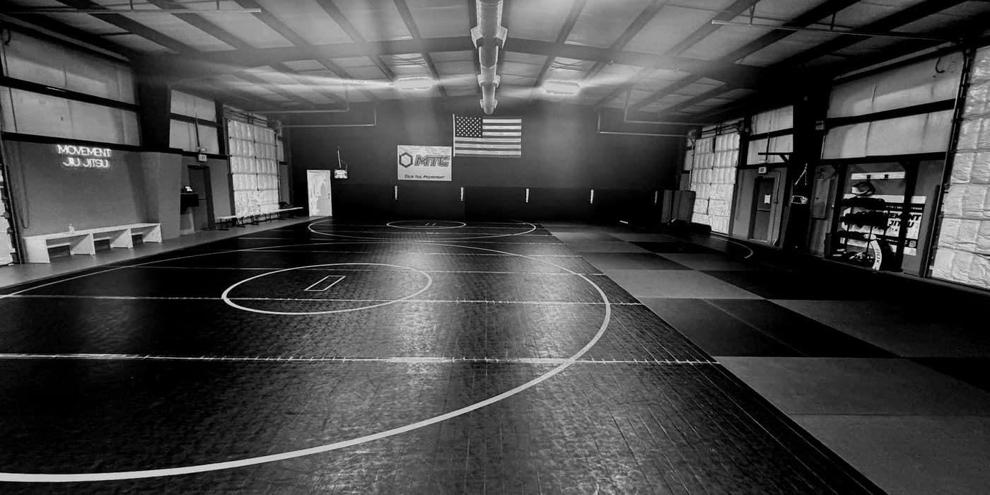 The Movement Training Center mat room in New Kent, Virginia, with the MTC Join the Movement banner